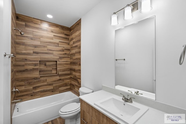 full bathroom featuring bathing tub / shower combination, vanity, and toilet