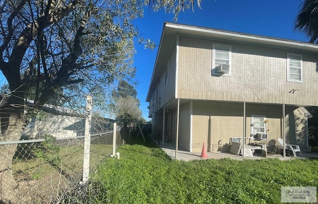 back of house with a patio and cooling unit