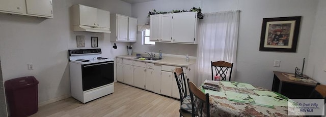 kitchen featuring white cabinetry, sink, white electric range oven, and light hardwood / wood-style floors