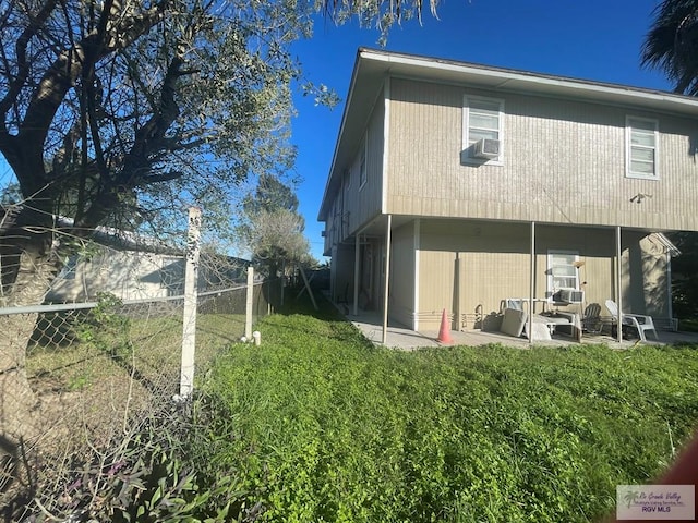 rear view of house featuring cooling unit and a patio