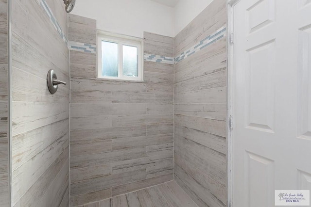 bathroom with a tile shower