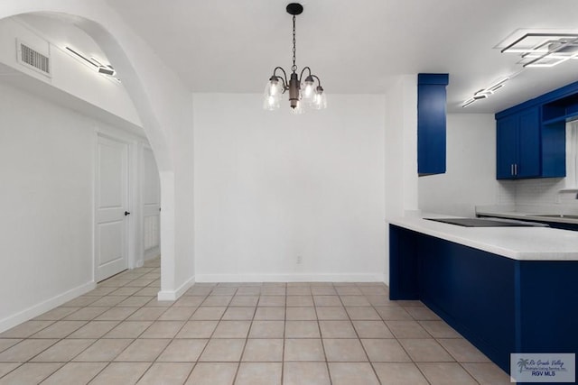 unfurnished dining area with light tile patterned floors and an inviting chandelier