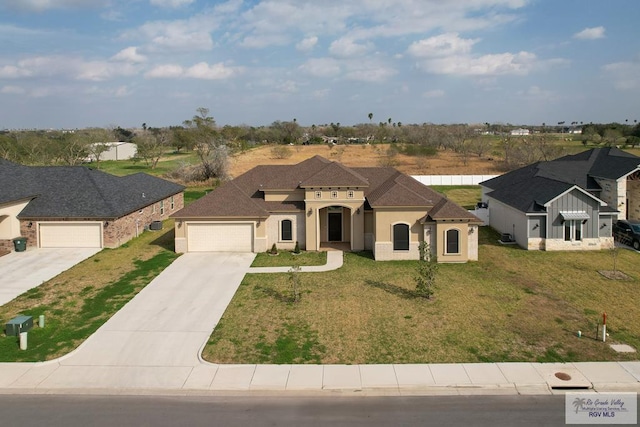 view of front of home with a garage and a front lawn