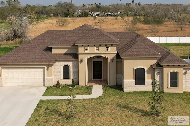 view of front facade with a garage and a front lawn