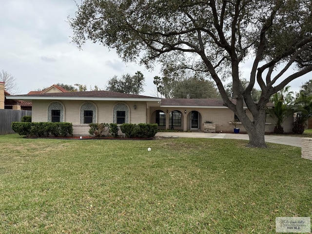 single story home with a front yard, fence, concrete driveway, and brick siding