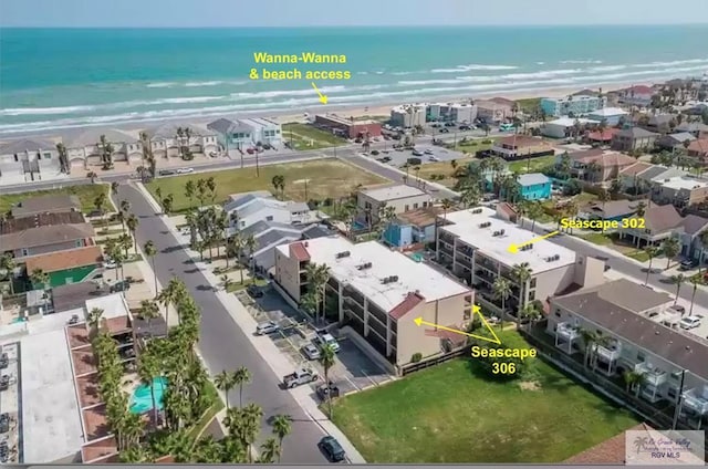 bird's eye view featuring a water view and a view of the beach