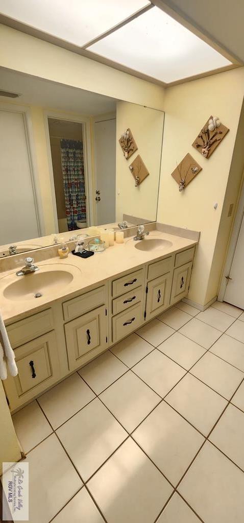 bathroom with tile patterned floors and vanity