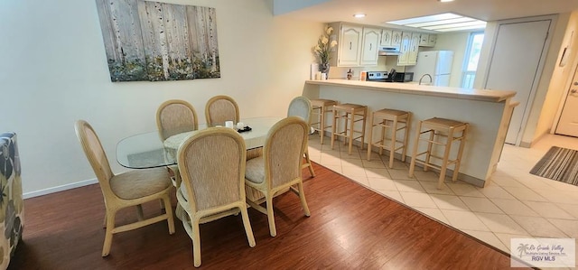 dining area with light hardwood / wood-style floors