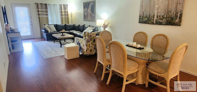 dining area with dark hardwood / wood-style flooring