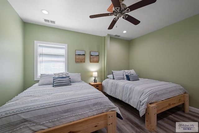 bedroom with ceiling fan and dark wood-type flooring