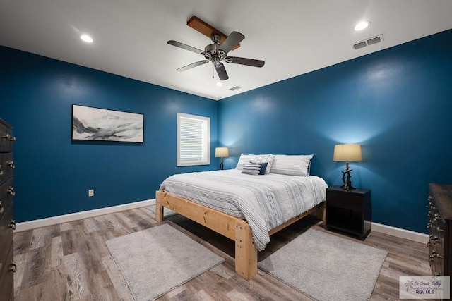 bedroom with ceiling fan and hardwood / wood-style flooring