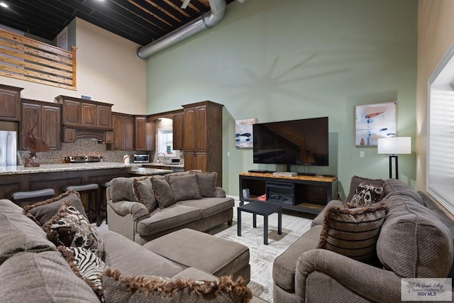 living room with a high ceiling and sink