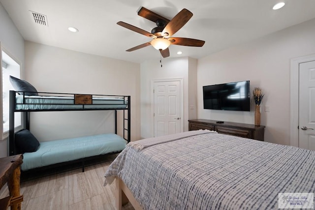 bedroom with ceiling fan and multiple windows