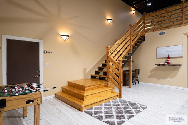 stairs featuring a towering ceiling