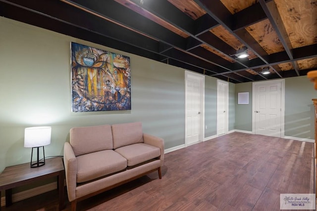 sitting room featuring beam ceiling and hardwood / wood-style floors