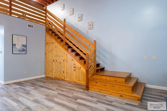 stairs featuring wood-type flooring