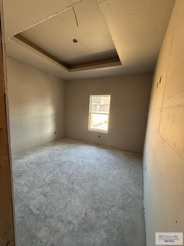 825 Milania Dr, La Feria, TX 78589 - empty room featuring a raised ceiling and unfinished concrete floors