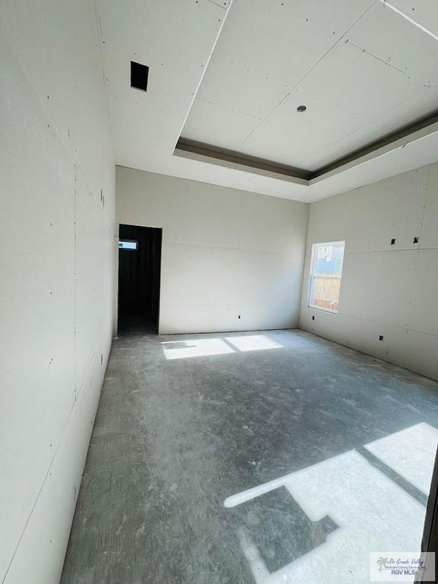 825 Milania Dr, La Feria, TX 78589 - spare room with concrete floors and a raised ceiling