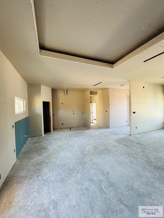 825 Milania Dr, La Feria, TX 78589 - empty room featuring concrete floors and a raised ceiling