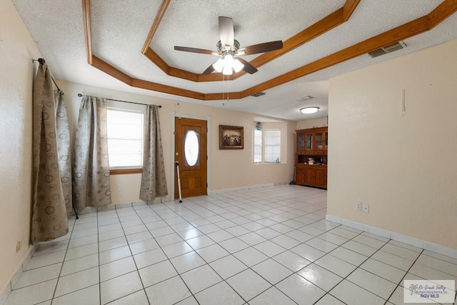 tiled foyer featuring ceiling fan, a textured ceiling, and a wealth of natural light