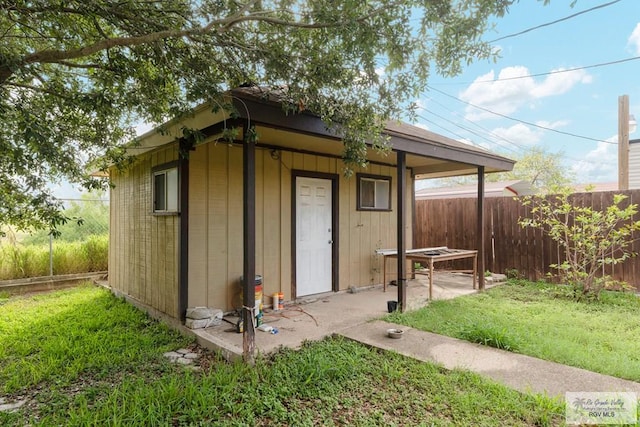 view of outdoor structure featuring a lawn