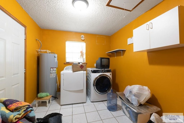 laundry room with washer and clothes dryer, cabinets, electric water heater, and a textured ceiling