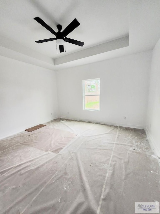 unfurnished room with a tray ceiling