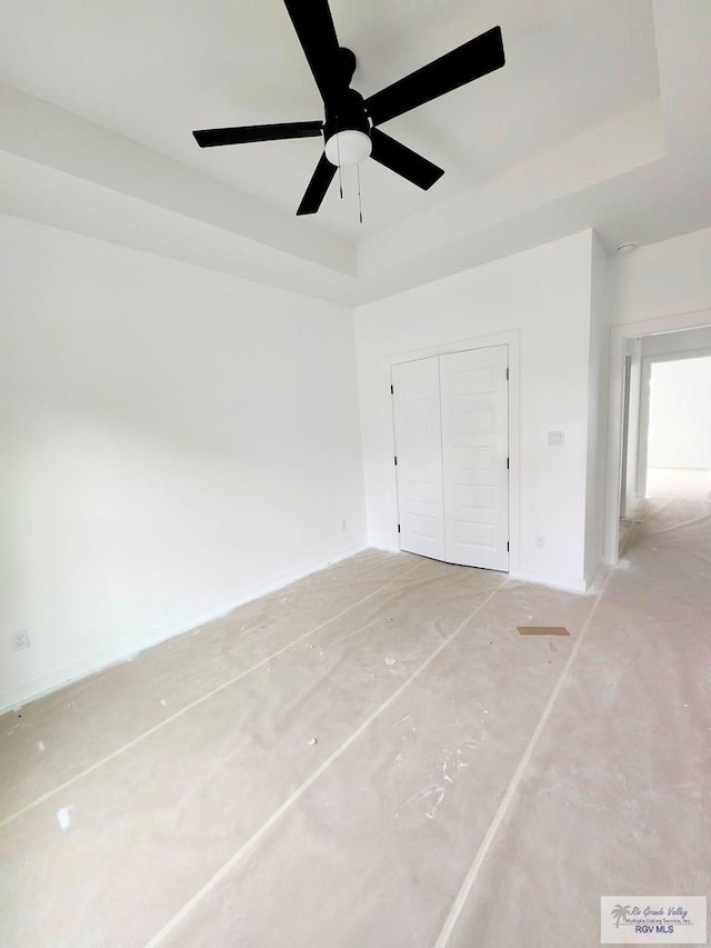 unfurnished room featuring a raised ceiling