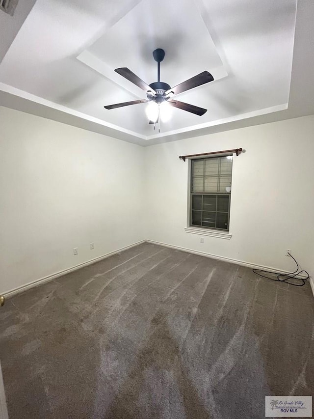1522 Autumn Ct Lot 23, Harlingen, TX 78552 - unfurnished room with a tray ceiling, ceiling fan, and dark carpet