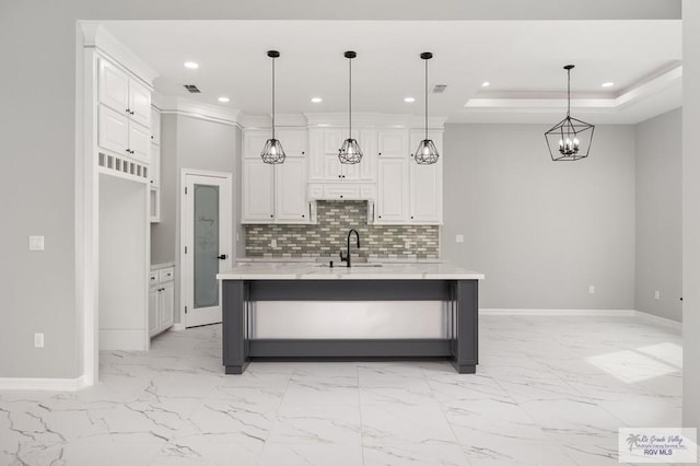 802 Olivia Dr, Mercedes, TX 78570 - kitchen with hanging light fixtures, white cabinets, a kitchen island with sink, and sink