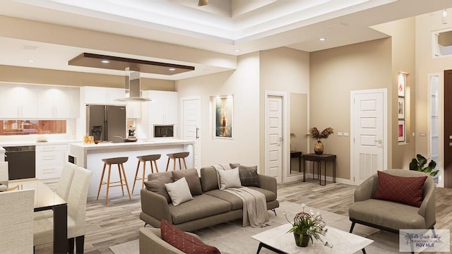 living room with a towering ceiling and light hardwood / wood-style flooring