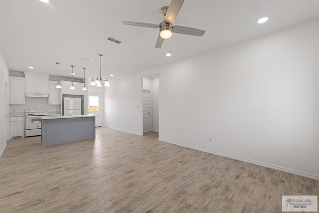 unfurnished living room featuring ceiling fan and light hardwood / wood-style floors