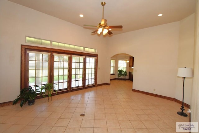 spare room featuring ceiling fan and light tile patterned flooring