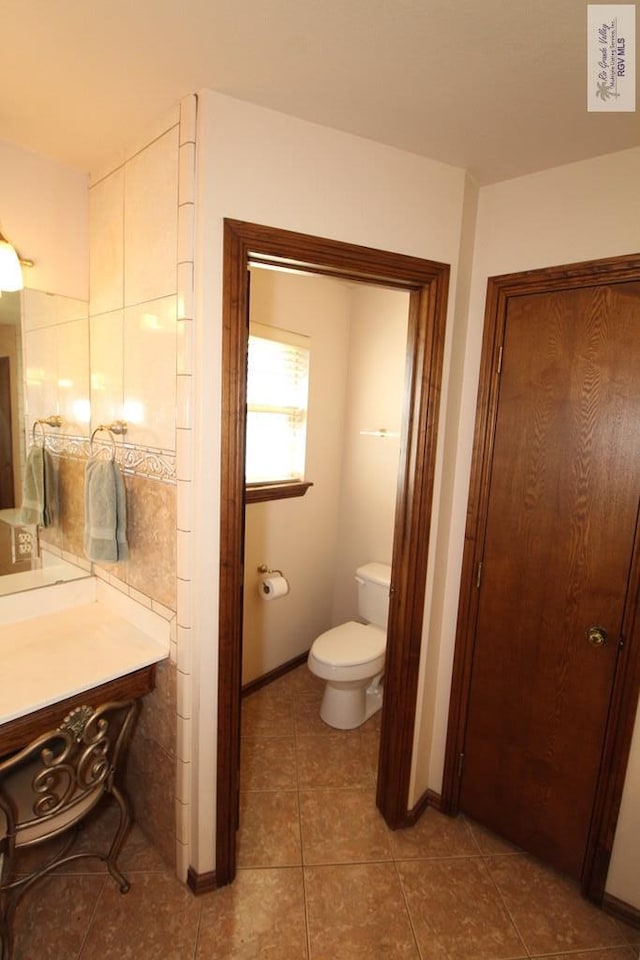 bathroom with tile patterned flooring and toilet