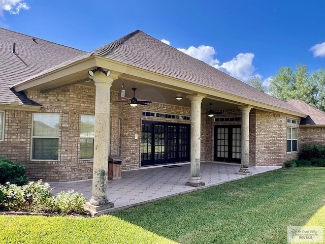 back of house with a patio, ceiling fan, and a lawn