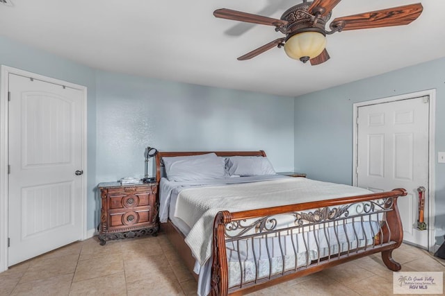 tiled bedroom with ceiling fan