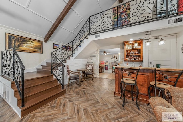 bar with parquet flooring, high vaulted ceiling, and ceiling fan