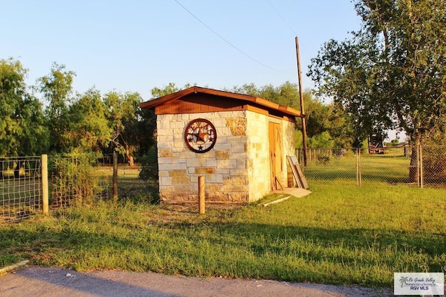 view of outbuilding with a lawn