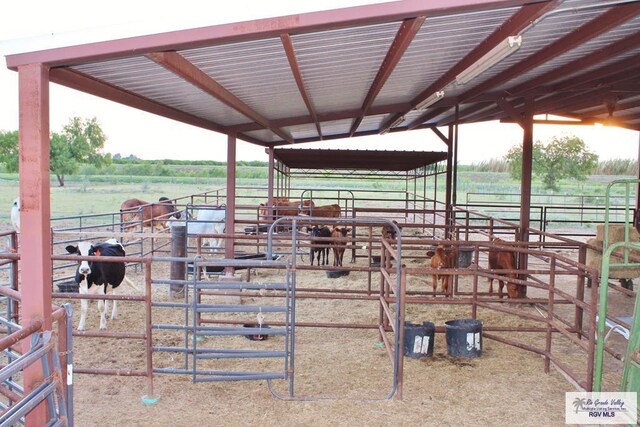 view of horse barn with a rural view