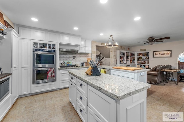 kitchen featuring white cabinets, a kitchen island, and stainless steel appliances