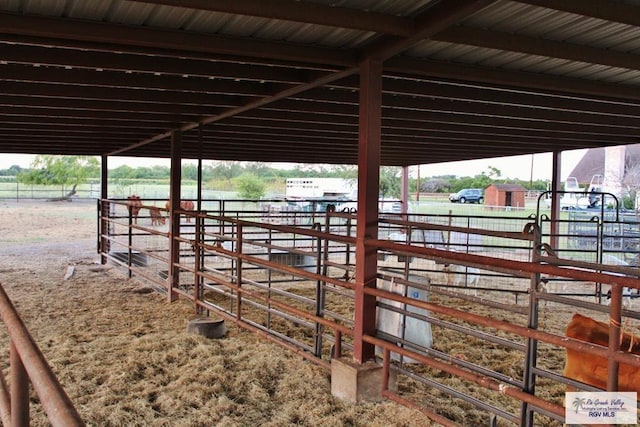 view of stable featuring a rural view