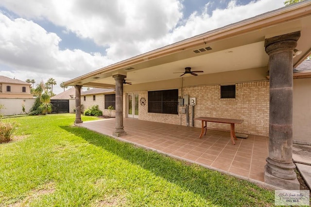 back of house featuring a patio, ceiling fan, and a lawn