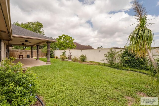 view of yard featuring ceiling fan and a patio area