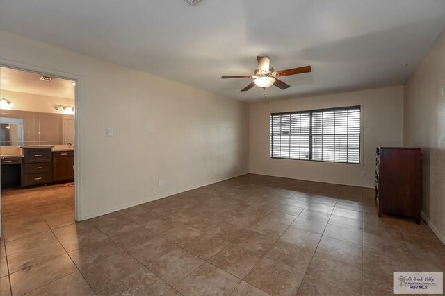 unfurnished room with ceiling fan