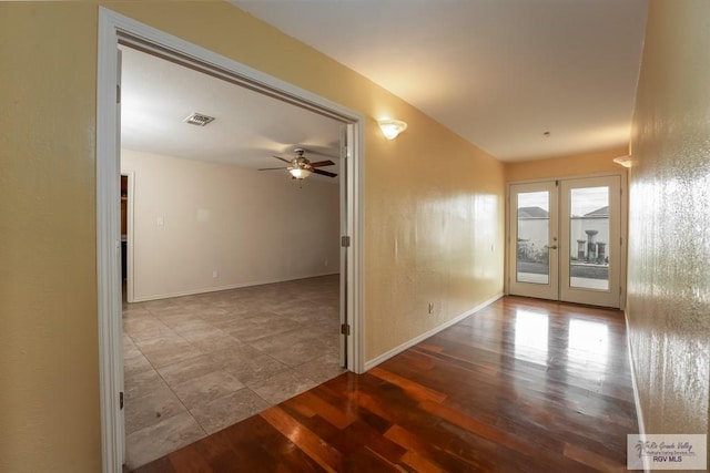 empty room with hardwood / wood-style floors, ceiling fan, and french doors