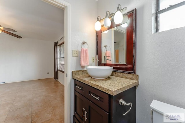 bathroom with ceiling fan, plenty of natural light, vanity, and tile patterned flooring