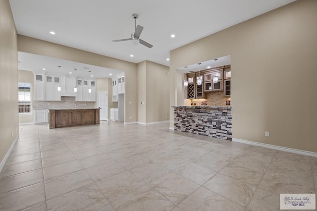 2402 S Christian Cir, Harlingen, TX 78550 - unfurnished living room with a ceiling fan, recessed lighting, and light marble finish floors