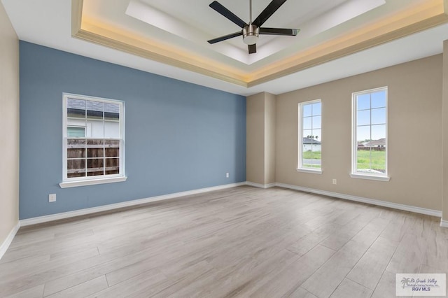 2402 S Christian Cir, Harlingen, TX 78550 - empty room with a tray ceiling, wood finished floors, and a ceiling fan