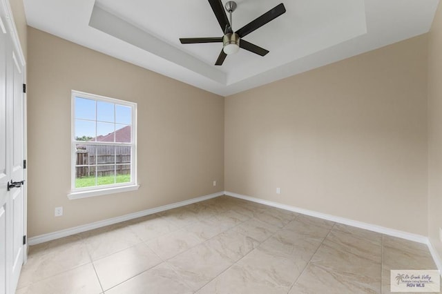 2402 S Christian Cir, Harlingen, TX 78550 - spare room with a ceiling fan and a tray ceiling
