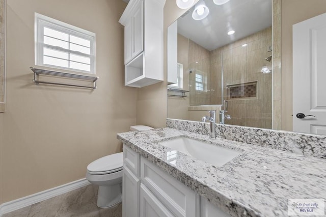2402 S Christian Cir, Harlingen, TX 78550 - bathroom with vanity, tiled shower, and marble look tiles